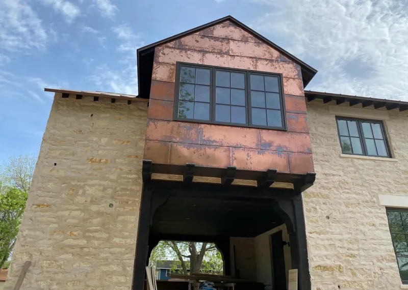 Copper metal panel facade on a stone building for Skylight Installation in Tustin